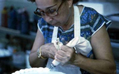 Cuban American woman decorating a cake at the Cafe Cubano in Little Havana - Miami, Florida.